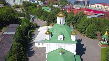 Aerial view of the ancient cave monastery with cityscape. Clip. Orthodox Monastery, memorial complex of monasteries surrounded by trees. video