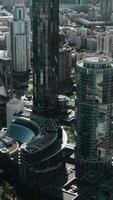 Helicopter view of the built-up summer city. Stock footage. Sunny view of the city center with skyscrapers and houses and a small pond where tourists walk. video