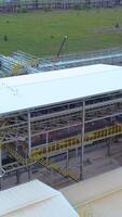 A developing province. Clip.Drone view of construction sites located near factories against the background of a bright shining sun. video