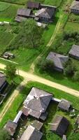 Top view of rustic cottages with green fields. Stock footage. Neat plots of village houses with green fields. Green plots with houses in cottage village in summer video