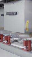 Close up of metal polishing machine during working process, equipment and technologies concept. Action. Machine with many rotating brushes cleaning and polishing metal sheet. video