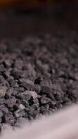Close up of crushed rock passing production line at mining industry. Stock footage. Conveyor belt with small gravel at the construction materials pruduction factory. video
