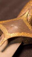 Close-up of patterns of handle of medieval weapon. Stock footage. Ancient weapons of Slavic or Eastern people in Museum on isolated background video