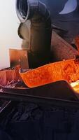 Molten material flows and cools in factory. Stock footage. Molten substance flows like lava down drain and is cooled by water at plant. Melting and cooling processes video