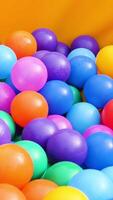 Colorful plastic balls in a pool for for children. Stock footage. Close up of lots of colored balls in a playground ball pool, having fun concept. video