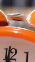Close up of retro alarm clock going off on blurred background. Stock fooatge. Orange alarm clock details for waking up in the morning. video