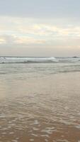 Beautiful landscape of sandy beach with long waves and blue cloudy sky. Action. Beautiful calm beach with in tropical island. video