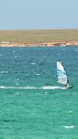 Man Windsurfing in the water during a sunny summer day. Shot. Beautiful view of the sea and windsurfer on a Sunny day video