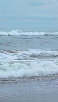 Seascape of beautiful waves on cloudy day. Clip. Beautiful coastal waves on background of horizon with cloudy sky. Coastal waves of North Sea on cloudy day video