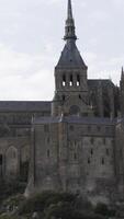 Mont Saint Michel, Normandy France, architecture concept. Action. Medieval abbey on the mountain of the same name on cloudy sky background. video