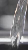 Close-up of water being poured into metal kettle. Action. Stream of clean water is poured into kettle. Water is poured into metal teapot for tea video