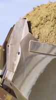 Close-up of excavator digging up ground. Stock footage. Digging operations using excavator to clear space for construction video