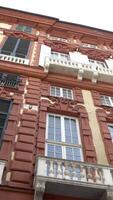 Bottom view of facade of residential building with old European architecture. Action. Beautiful exterior of house with old architecture and high Windows video