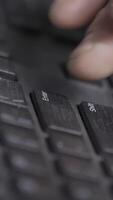 Close-up of finger over black laptop keys pressing enter button, computers and technologies concept. Action. Man finger pushing enter key on black laptop keyboard. video
