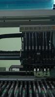 Automatic pick and place machine is installing components on circuit board. Creative. Assembly line on electronics and circuit board manufacturing factory. video