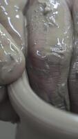 Close up of hands of a potter while creating a clay jar, ceramics production concept. Stock footage. The sculptor male hands in the workshop making a vase or jar. video