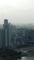 Top view of modern gray city in cloudy weather. Stock footage. Grey cloudy city with river and fog. Cloudy day hanging over modern city video