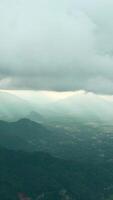 Beautiful view of mountain green valley with clouds and sunlight. Action. Picturesque landscape of green mountains and low clouds with sun breaking through. Sun's rays on horizon in green mountain video