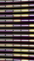Horizontal flow of abstract neon lines of purple and yellow colors with camera lens distort on black background. Animation. Narrow stripes devided into segments, seamless loop. video