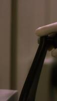 Close-up view of hand in white protective glove turning the large black handle of some metal box or storage. Stock footage. Vault door handle and dial video
