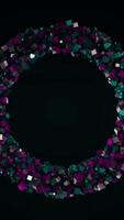 Abstract 3D ring created by tiny small particles that flying away isolated on black background. Animation. Colorful squares moving into all the sides. video