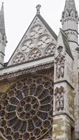 Bottom view of Gothic architecture of European Abbey. Action. Beautiful Gothic architecture of old building with rose window. Architectural European landmark video
