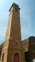 Ancient clock tower in fortress. Action. Beautiful sunny view of stone walls and clock tower in ancient fortress. Ancient fortress with clock tower on sunny summer day video