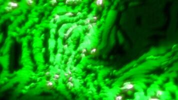 Green and orange background. Motion. Boiling mass with white beads inside made in computer graphics. video