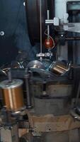 Coils with copper wire rotate on machine. Creative. Rotating coils of copper wire on industrial machine. Metallurgical plant with automated equipment for wire production video