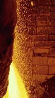 Molten raw materials in furnace. Stock footage. Close-up of bright molten substance pouring out in stream in industrial furnace video