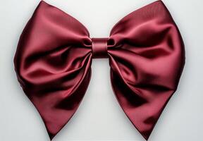 Elegant burgundy satin bow for gift wrapping or decorations on a neutral background photo