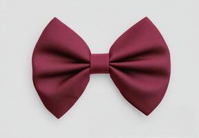 Elegant burgundy bowtie arranged neatly on a light background for formal wear styling photo