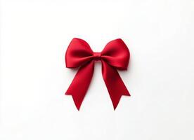 Bright red ribbon bow placed elegantly on a white surface for gift decorating photo