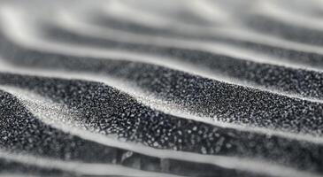 Abstract patterns of black and white sand at a beach during sunrise photo