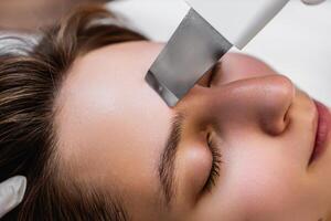 Ultrasonic cleaning of the face. Skin peeling. photo