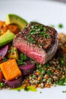 Delicious grilled steak served on a bed of quinoa with vibrant vegetables and avocado slices photo