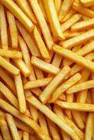 Golden fried potatoes scattered on a bright yellow surface for a delightful snack experience photo