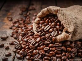 Dark brown coffee beans being poured out of a sack on a wooden background. This image conveys the freshness and aroma of the coffee beans. photo