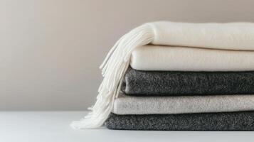 Cozy wool blankets stacked neatly in a minimalist setting for a warm and inviting atmosphere photo
