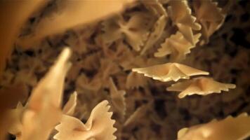 Farfale pasta falls down. Filmed on a high-speed camera at 1000 fps. High quality FullHD footage video