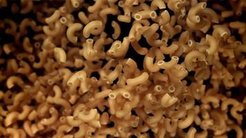 The dry pasta flies up and falls down. Filmed on a high-speed camera at 1000 fps. High quality FullHD footage video
