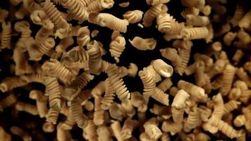 Fusili pasta rises and falls. Filmed on a high-speed camera at 1000 fps. High quality FullHD footage video