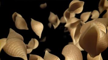 Dry pasta flies down. Filmed on a high-speed camera at 1000 fps. High quality FullHD footage video
