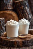 Fresh yogurt in a glass jar on a rustic wooden table beside a window photo