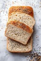 Slices of whole grain bread topped with seeds on a wooden cutting board photo