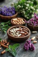 Variety of herbal supplements and vitamins arranged in wooden bowls on a rustic table with flowers photo