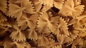 Farfale pasta flies in and falls. Filmed on a high-speed camera at 1000 fps. High quality FullHD footage video