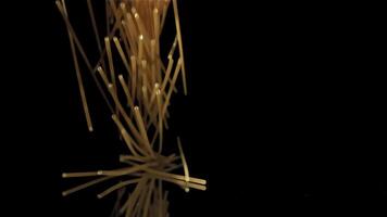 Dry spaghetti falling on a black background. Filmed on a high-speed camera at 1000 fps. High quality FullHD footage video