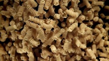 Fusili pasta rises and falls. Filmed on a high-speed camera at 1000 fps. High quality FullHD footage video