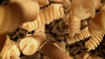 Fusili pasta falls down. Filmed on a high-speed camera at 1000 fps. High quality FullHD footage video